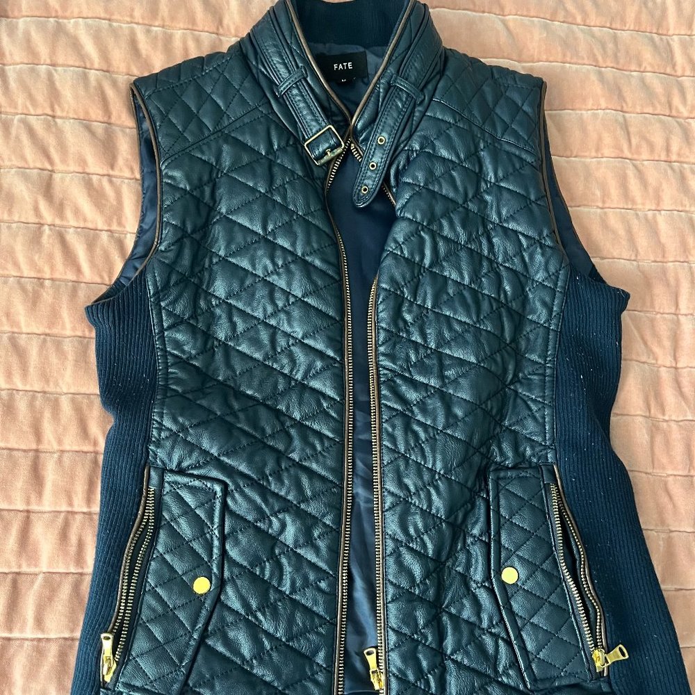 Navy blue faux leather vest, with gold zipper and buckle detail